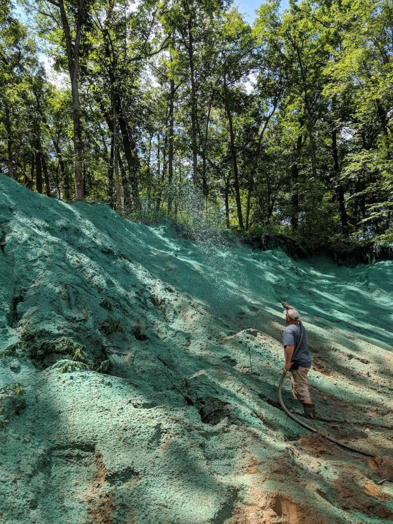 Hydroseeding applied to a slope for grass establishment